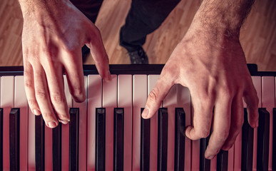Man's hand playing piano.
