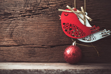 christmas bird and ball decoration on wood background with copy