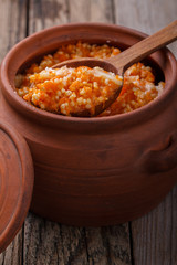 Millet porridge with pumpkin and milk in a clay pot
