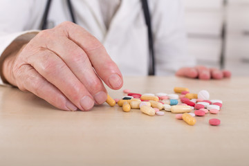 Old man hand with pills