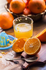 Fresh oranges. Cut oranges. Pressed orange manual method. Oranges and sliced oranges with juice and squeezer.