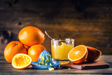 Fresh oranges. Cut oranges. Pressed orange manual method. Oranges and sliced oranges with juice and...