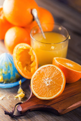 Fresh oranges. Cut oranges. Pressed orange manual method. Oranges and sliced oranges with juice and squeezer.