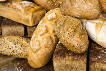 Stack of traditional bread on the street market. Assortment of baked bread.