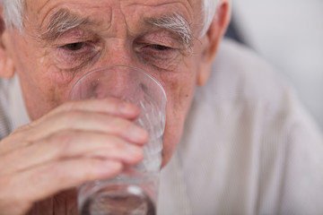 Old man drinking water