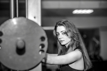 Fototapeta premium Young pretty girl work out in the gym
