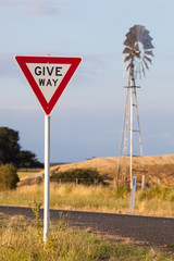 Give way sign and windmill