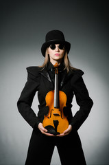 Woman playing classical violin in music concept