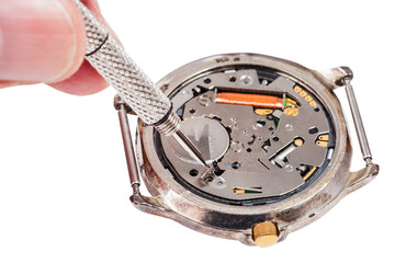 repairer replaces battery in quartz watch isolated