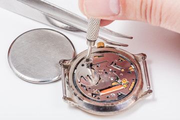 watchmaker replaces battery in quartz watch