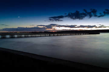 Fototapeta na wymiar Horizontal vivid vibrant sunset pier dock background backdrop