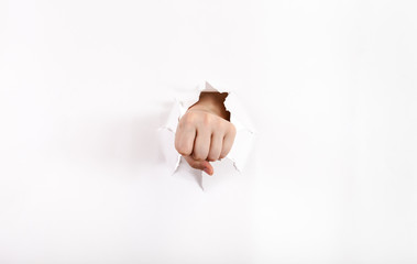 front view of the fist punches a paper