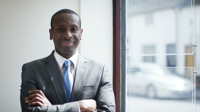  Confident successful african businessman smiling into camera