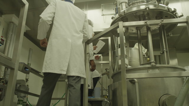 Scientists in pharmaceutical research factory