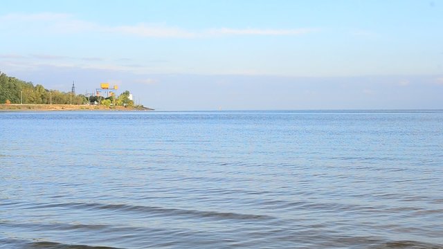 Water summer landscape with hydroelectric power station far off