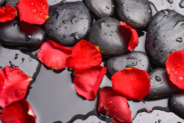 Red rose petals and therapy stones 