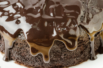 Dark chocolate sauce on top of dark chocolate cake
