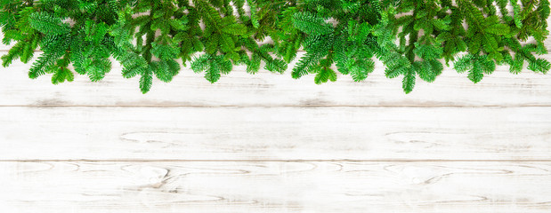 Christmas tree branches on wooden background banner