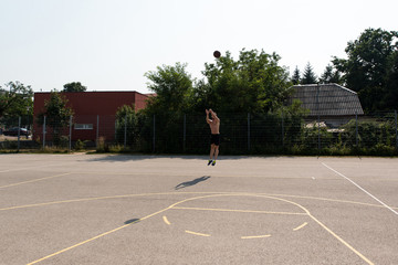 Basketball Player Shooting In A Playground