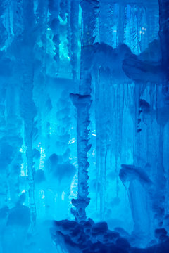 Textured background of the interior of an ice cave with blue lighting