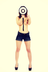 Shirtless woman screaming by megaphone.
