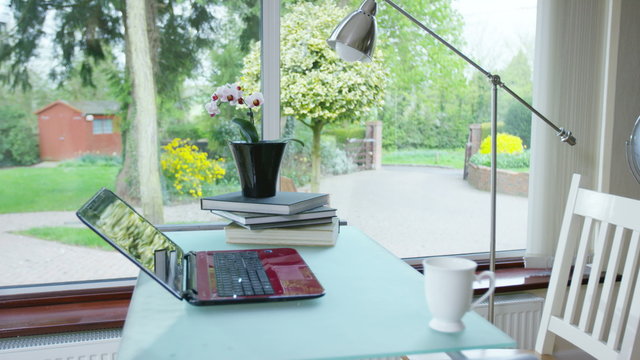  Pretty home office working space with desk and laptop computer. No people. 