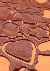 Dough for gingerbread in shape of heart, star and christmas tree