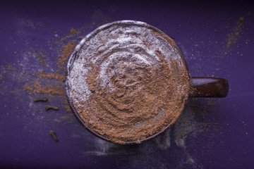 Cup of cappuccino on a purple background