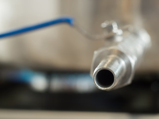 Stainless faucet kettle on the gas stove