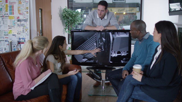  Young designers in meeting discussing product design