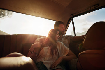Relaxed young couple in a car