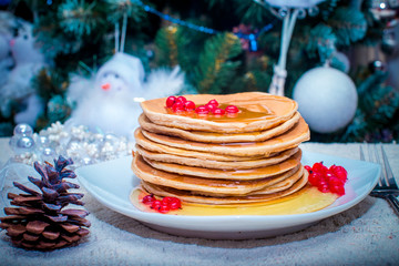 Stack of fresh golden pancakes or flapjacks topped