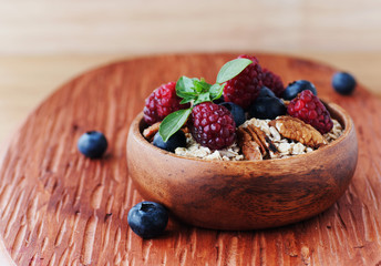 bunch of radishes lies on plate, wooden background, selective focus
