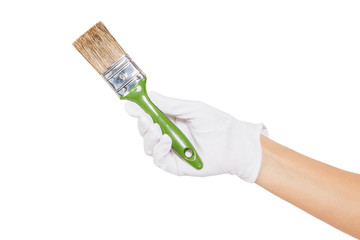 The hand in white glove with green paintbrush