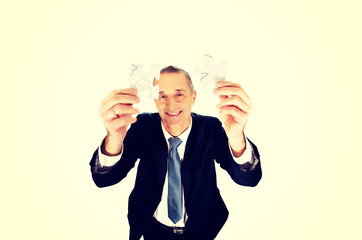 Businessman trying to connect puzzle pieces.