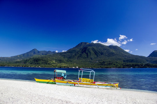 Boats on the white beach of tropical island