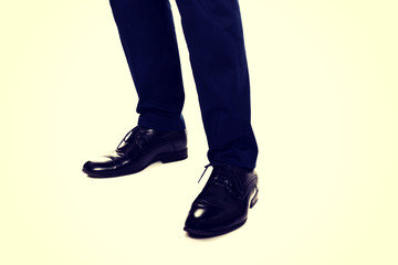 Close-up of businessman feet in black boots 