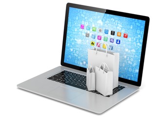 laptop and  shopping pags on white background