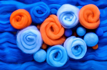 Eight stylized roses made of wool for felting. Blue and orange