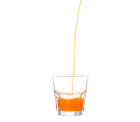 Juice pouring into glass isolated on white