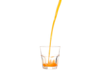 Juice pouring into glass isolated on white