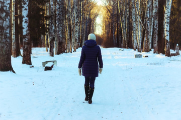 Fototapeta na wymiar woman walk park winter snow back