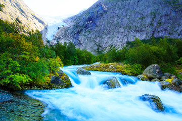 Eternal glaciers and waterfalls in the mountains .