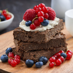 chocolate brownie cake with nuts and fresh berries, closeup