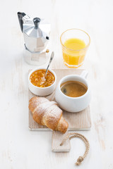 Coffee with fresh croissant, orange juice and jam 