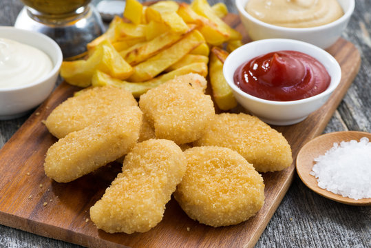 chicken nuggets with french fries and tomato sauce