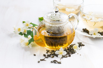 green tea with jasmin on white table