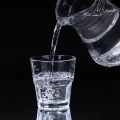 Water pitcher pouring a glass of fresh water