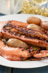 boiled octopus with potato on white plate