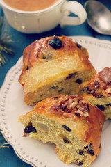 Christmas cake with dry fruits on white plate and cup of coffee